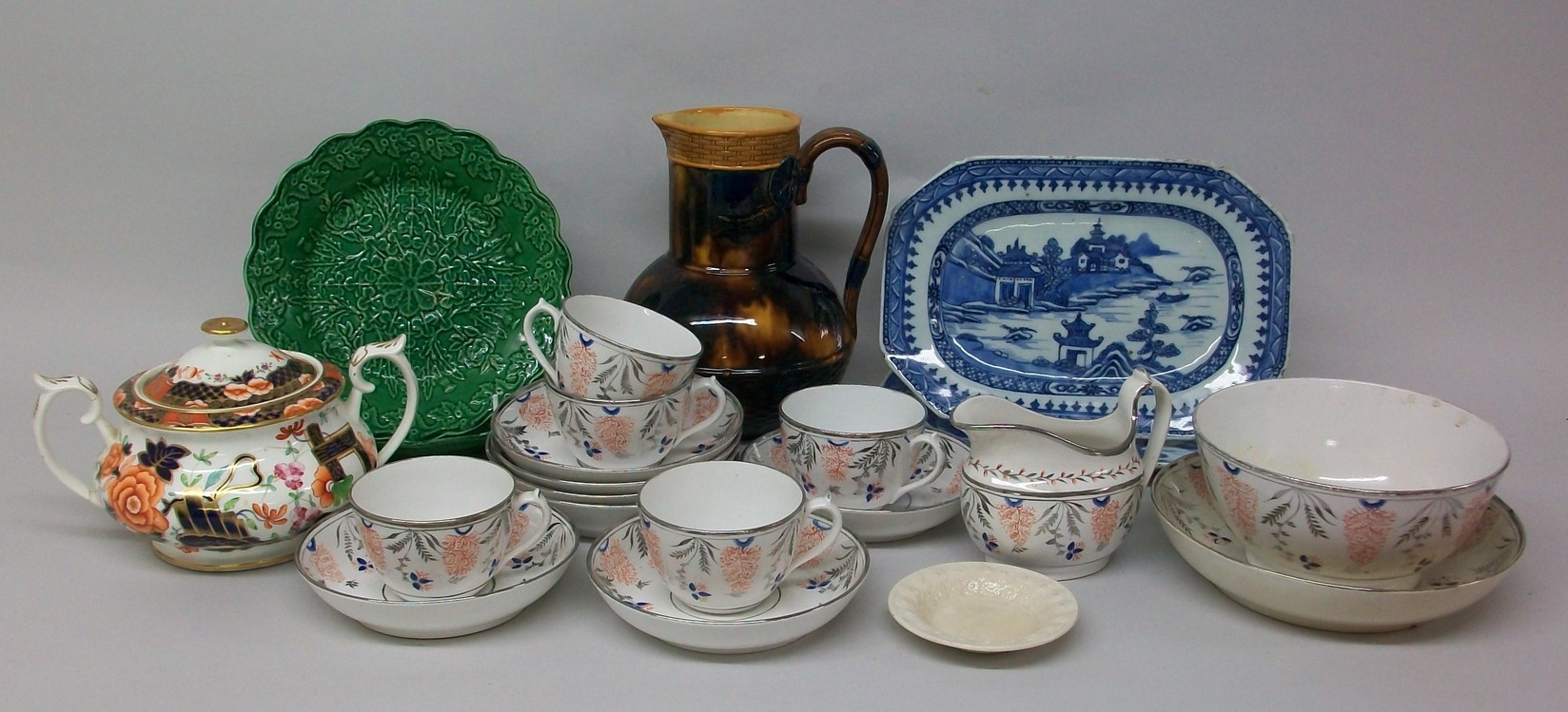 A pair of Qing Dynasty, 19th century, blue and white meat platters, a pair of green leaf majolica