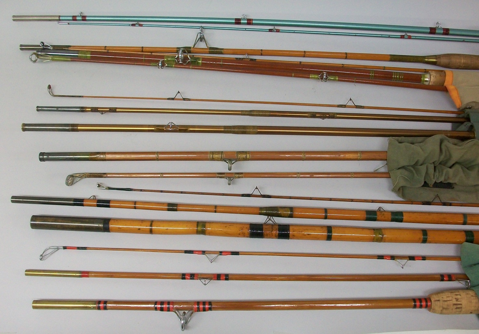 A group of seven vintage fishing rods comprising a Hardy Glaskona rod, Seaky Octopus rod, Poolson