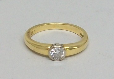 A diamond solitaire ring on 18ct gold band, 0.4ct clear white, size N.