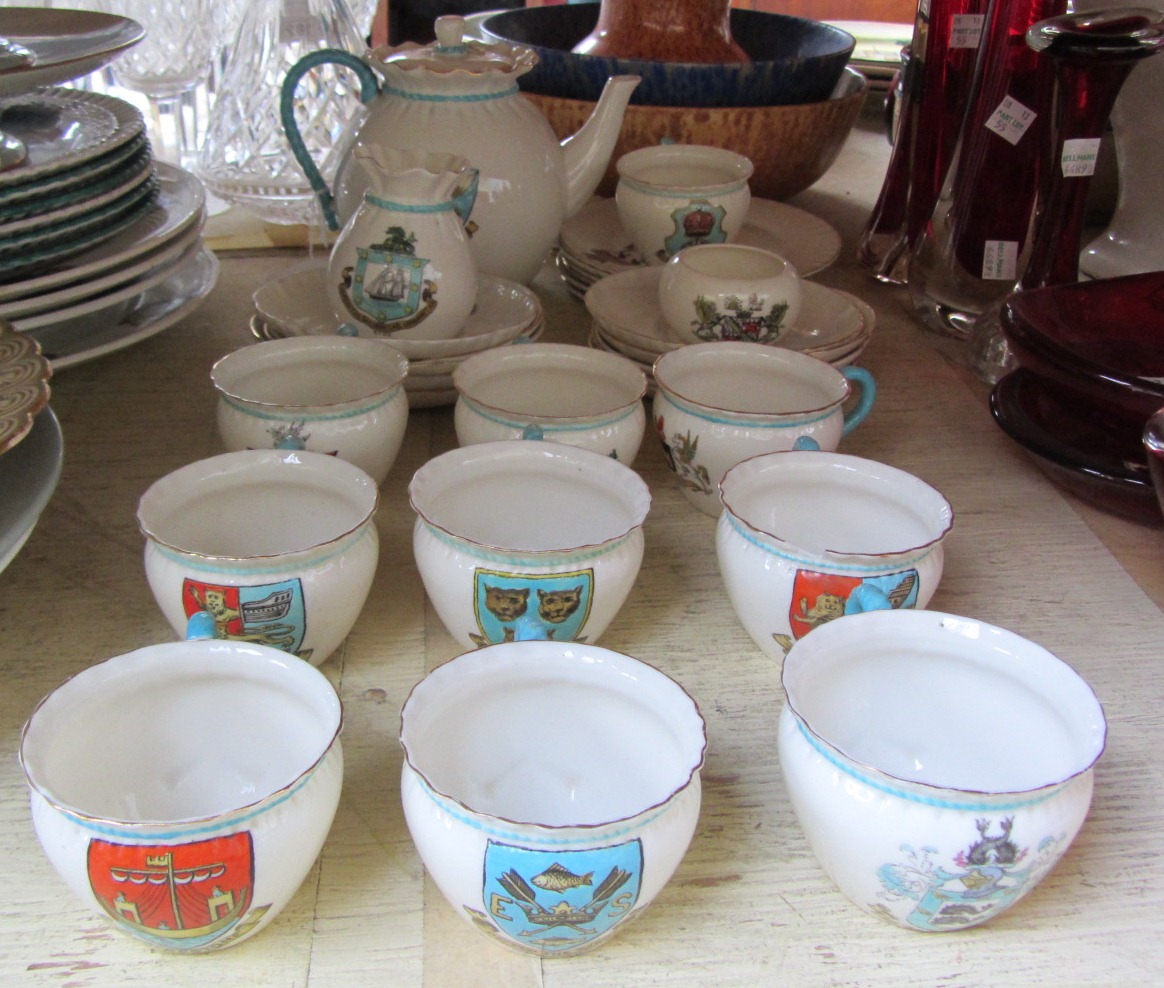 A Goss crested porcelain matched part tea service, comprising; lidded teapot, milk jug, ten teacups,