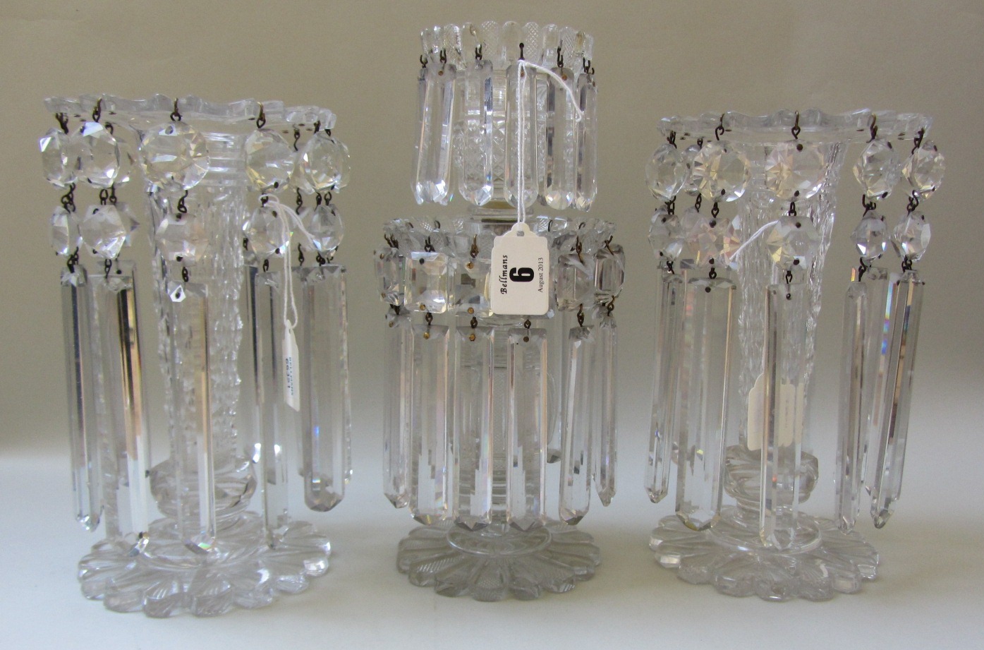 A pair of cut glass clear lustres, late 19th century, each raised on a shaped circular foot with