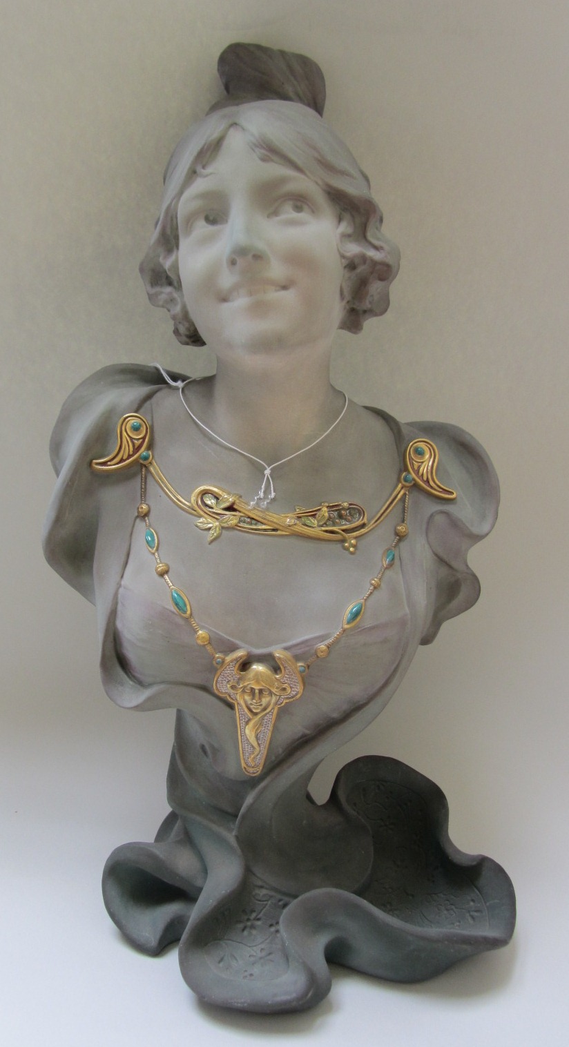 An Art Nouveau style earthenware bust, 20th century, modelled and cast as a young woman wearing an