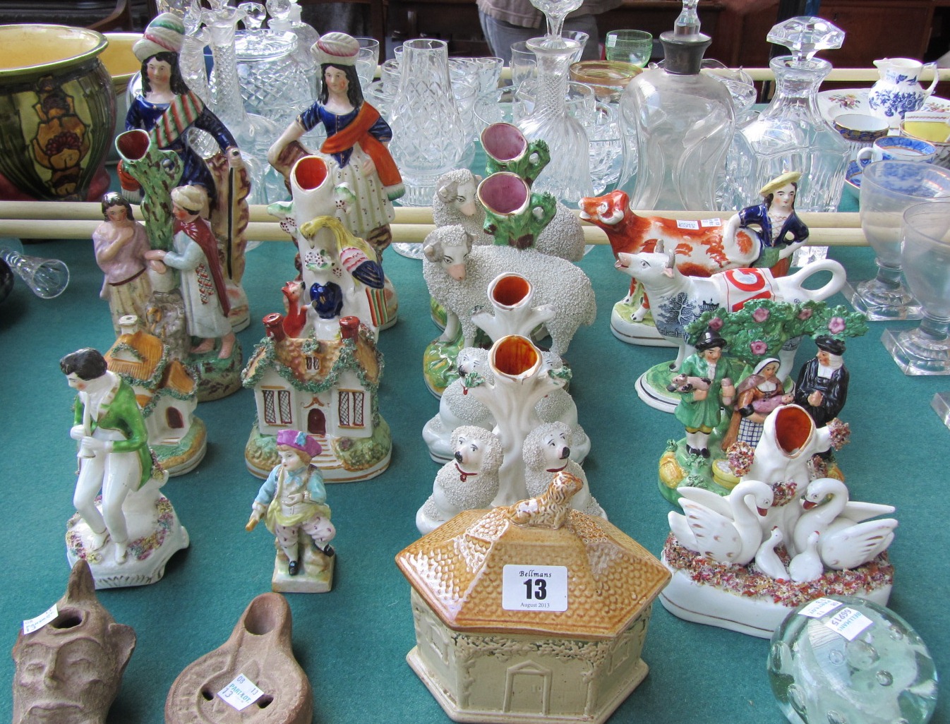 A quantity of Staffordshire pottery figures, including; a pair of highland figures in traditional