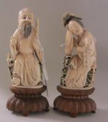 A pair of Chinese ivory figures, 20th century, one carved as a seated sage seated drinking tea and