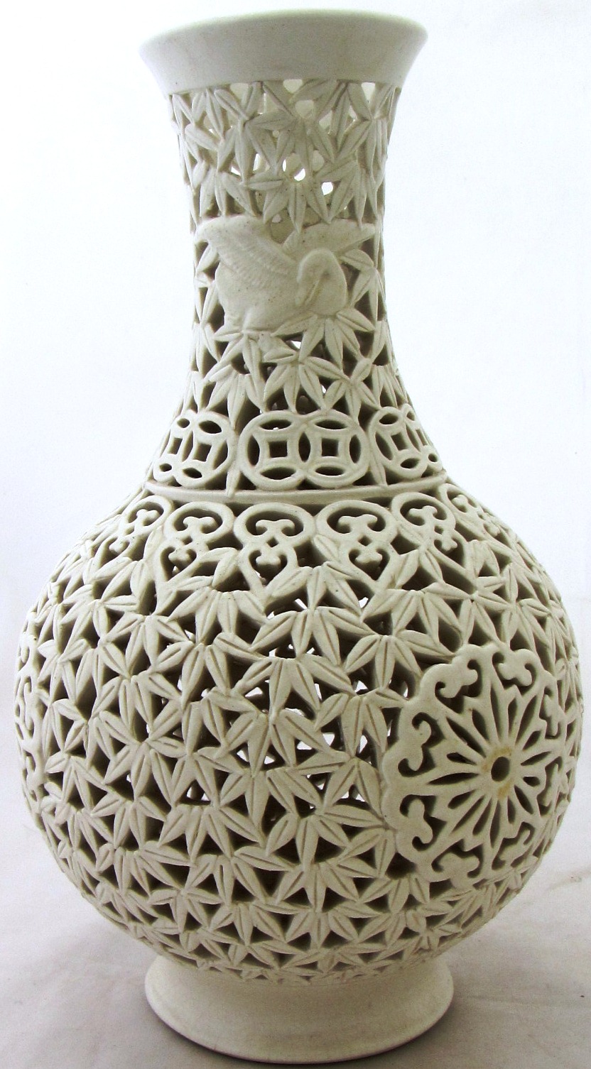 A pierced white glaze Chinese vase, moulded with birds, mark to base, 31cm high.