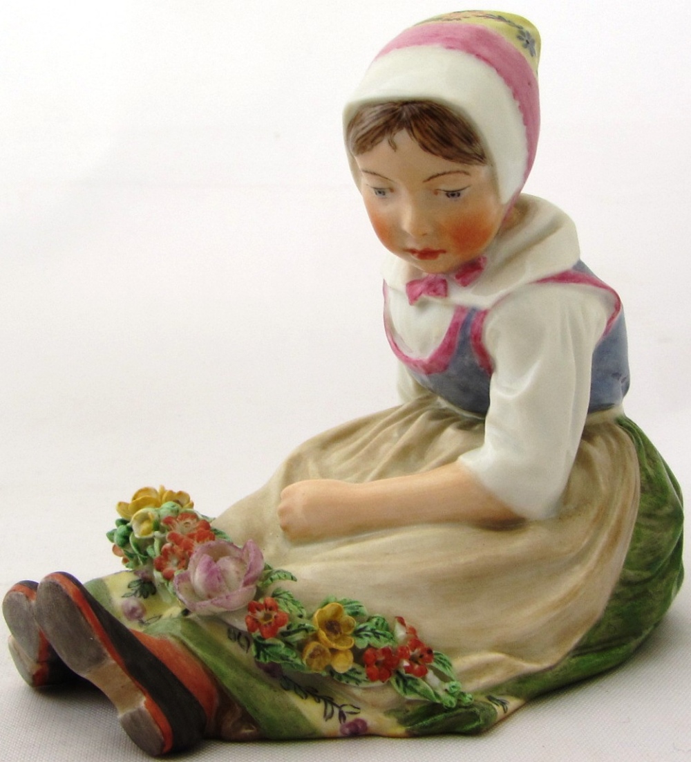 A Royal Copenhagen porcelain figure of a young Dutch girl in regional costume 'Sjalland' No 12418 by