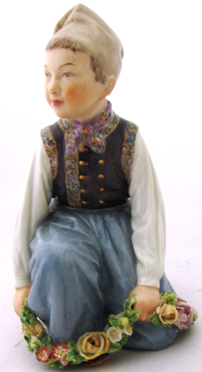 A Royal Copenhagen porcelain figure of a young Dutch girl in regional costume 'Amager' No 12414 by