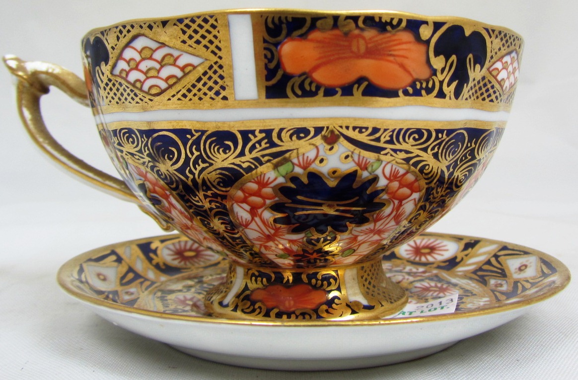 A Royal Crown Derby part tea service, decorated in an Imari pattern, comprising; four tea cups, five
