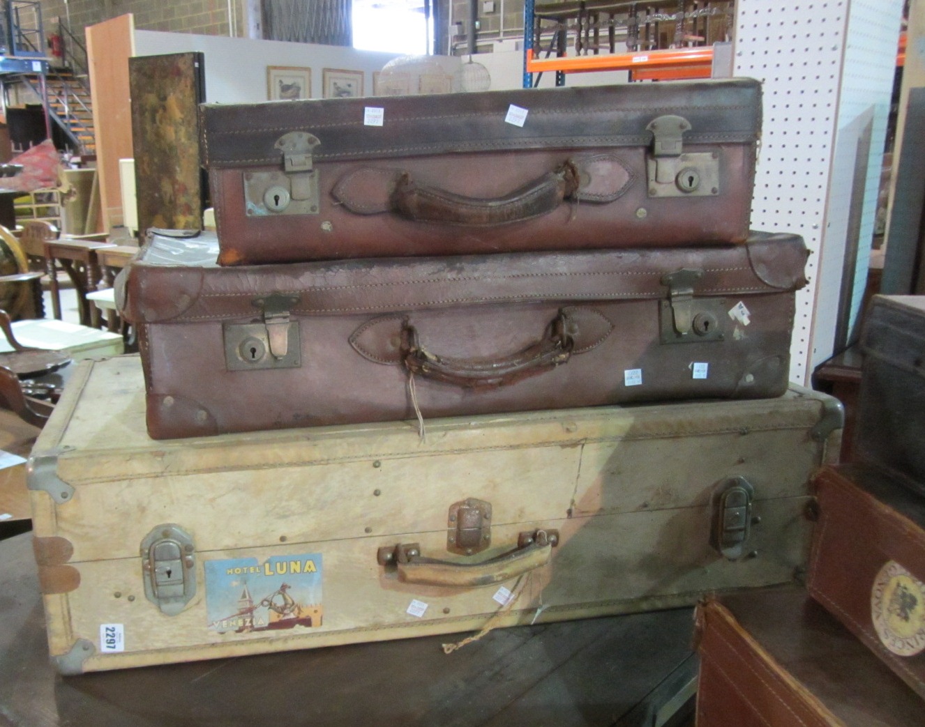 Two brown leather suitcases with one pigskin suitcase.