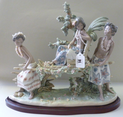 A Lladro porcelain figure group, No 1. 496, `Fiesta Tropical`, on a shaped wooden base with