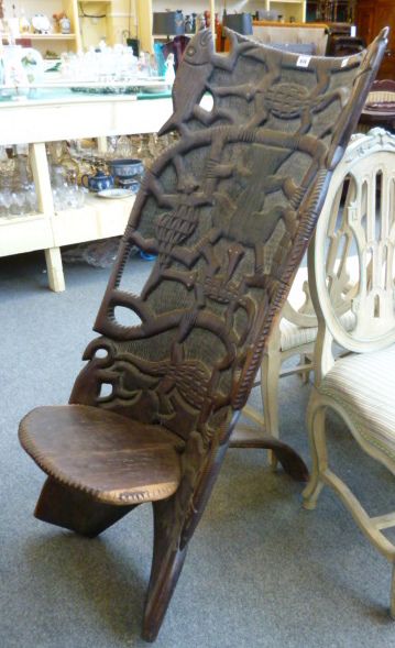 A carved African hardwood dug out chair