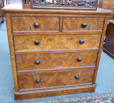 A 19th century figured walnut chest of two short and three long graduated drawers, 123cm wide.