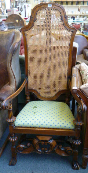 A walnut framed open armchair of William and Mary design.