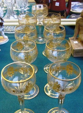 A set of nine French or Bohemian cut and gilt glass wine glasses, 17.2cm (9).