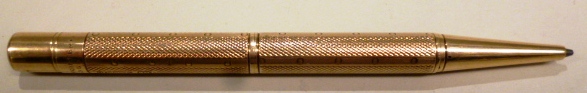 A 9ct gold cased Baker`s Pointer propelling pencil, with engine turned decoration, Birmingham 1928.