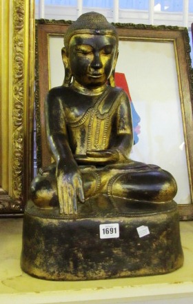 A South East Asian gilt lacquer figure of a seated Buddha, 20th century. 47cm high