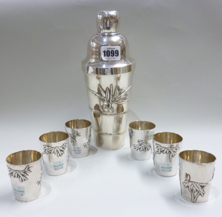 A Chinese cocktail shaker, decorated with bamboo, with a matching set of six cocktail beakers,