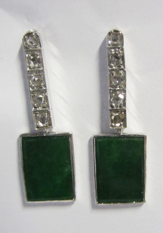 A pair of jade and diamond set pendant earrings, each mounted with a rectangular dark green jade