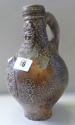 A Rhenish brown saltglazed stoneware bellarmine, 17th century, of pear form, the neck applied with a