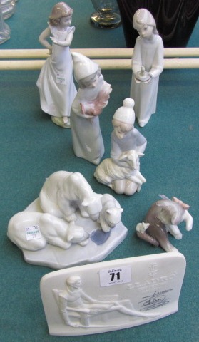 Seven Lladro porcelain items, including; a polar bear group, collectors plaque, a girl with a sheep,