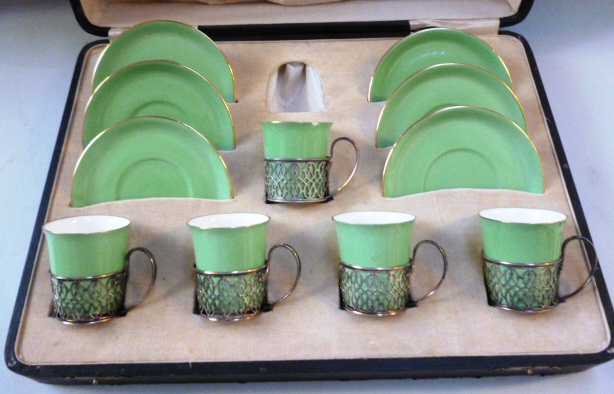 A Shelley porcelain six piece coffee service (lacking one cup) with five silver mounts and a