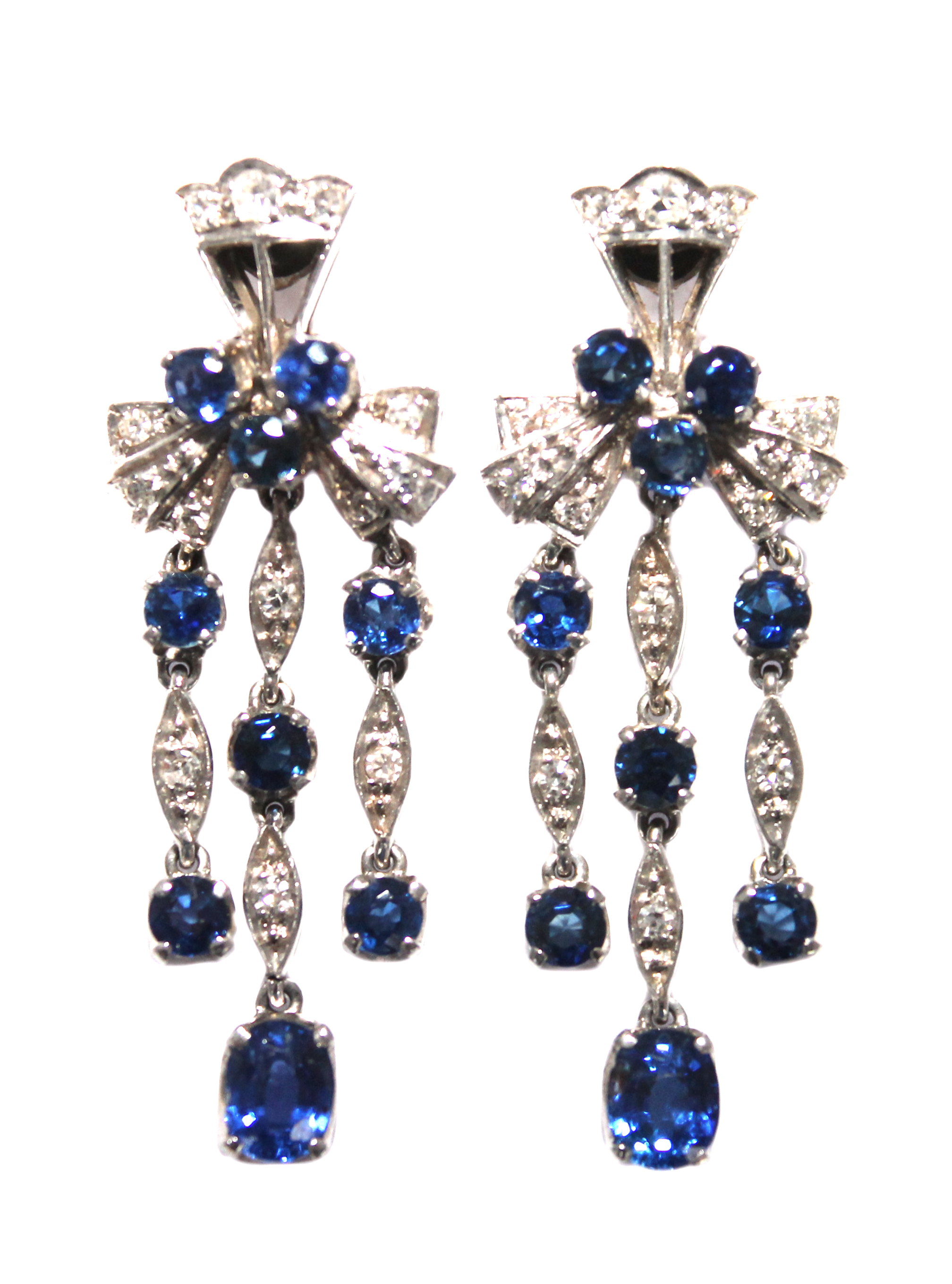 A pair of sapphire and diamond set pendant earrings, each with a trefoil shaped surmount and with