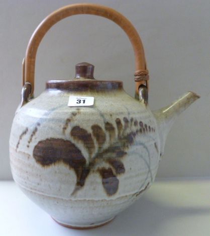 A stoneware teapot and cover by David Leach with cane swing over handle (a.f) 22.5cm high