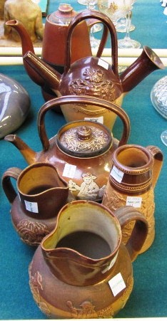 Two Doulton salt glaze stoneware harvest jugs, a Doulton lidded teapot, a Charles Haskin `