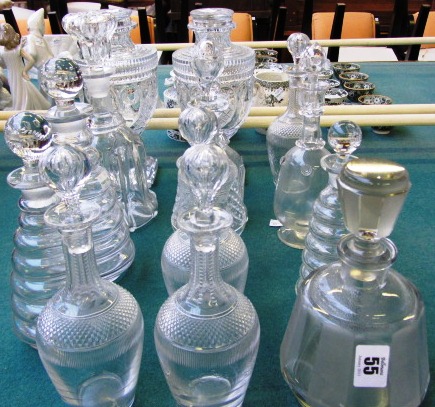 A pair of lidded glass urns and five 20th century decanters and stoppers, (a.f.) and a quantity of