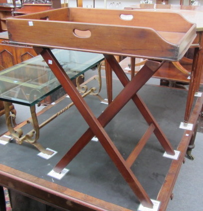 An early 19th century mahogany rectangular butlers tray on a later stand 75cm wide.
