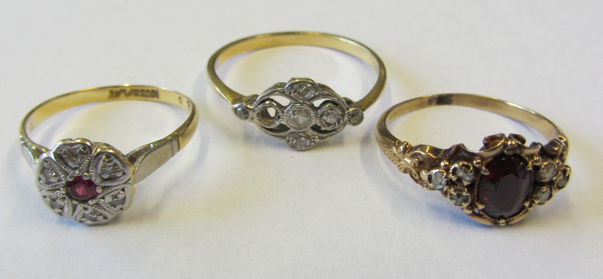 A gold and diamond set ring, pierced in a panel shaped design, mounted with circular cut diamonds (