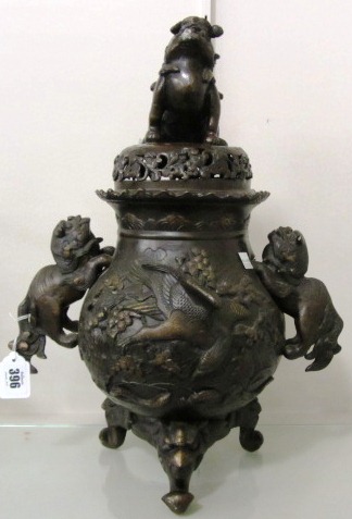 A Chinese bronze two-handled censer and cover, circa 1900, decorated in high relief with birds in