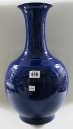 A large Chinese porcelain vase, late 19th/20th century, of bottle form, covered in a deep blue