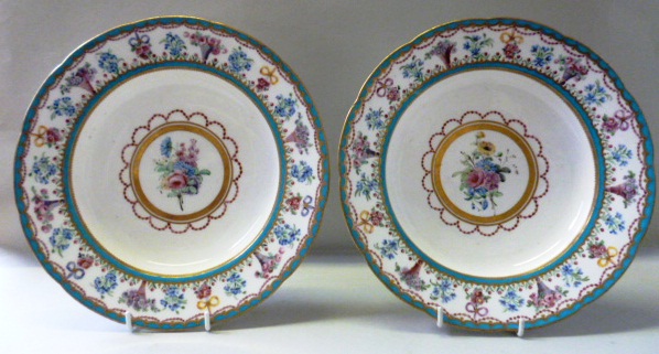 A pair of Sevres bleu celeste soup plates, 1790`s, each painted in the centre with a group of