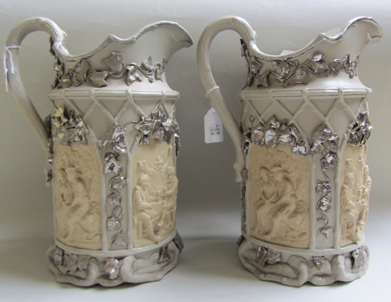 A pair of continental part silvered stoneware jugs, mid 19th century, probably German, impressed pad