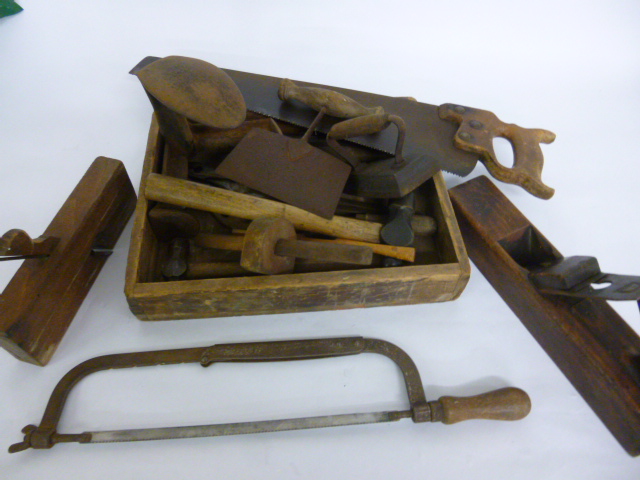 Wooden box of mixed tools including shoe last, flat iron. hammers, gauge, saws, planes etc