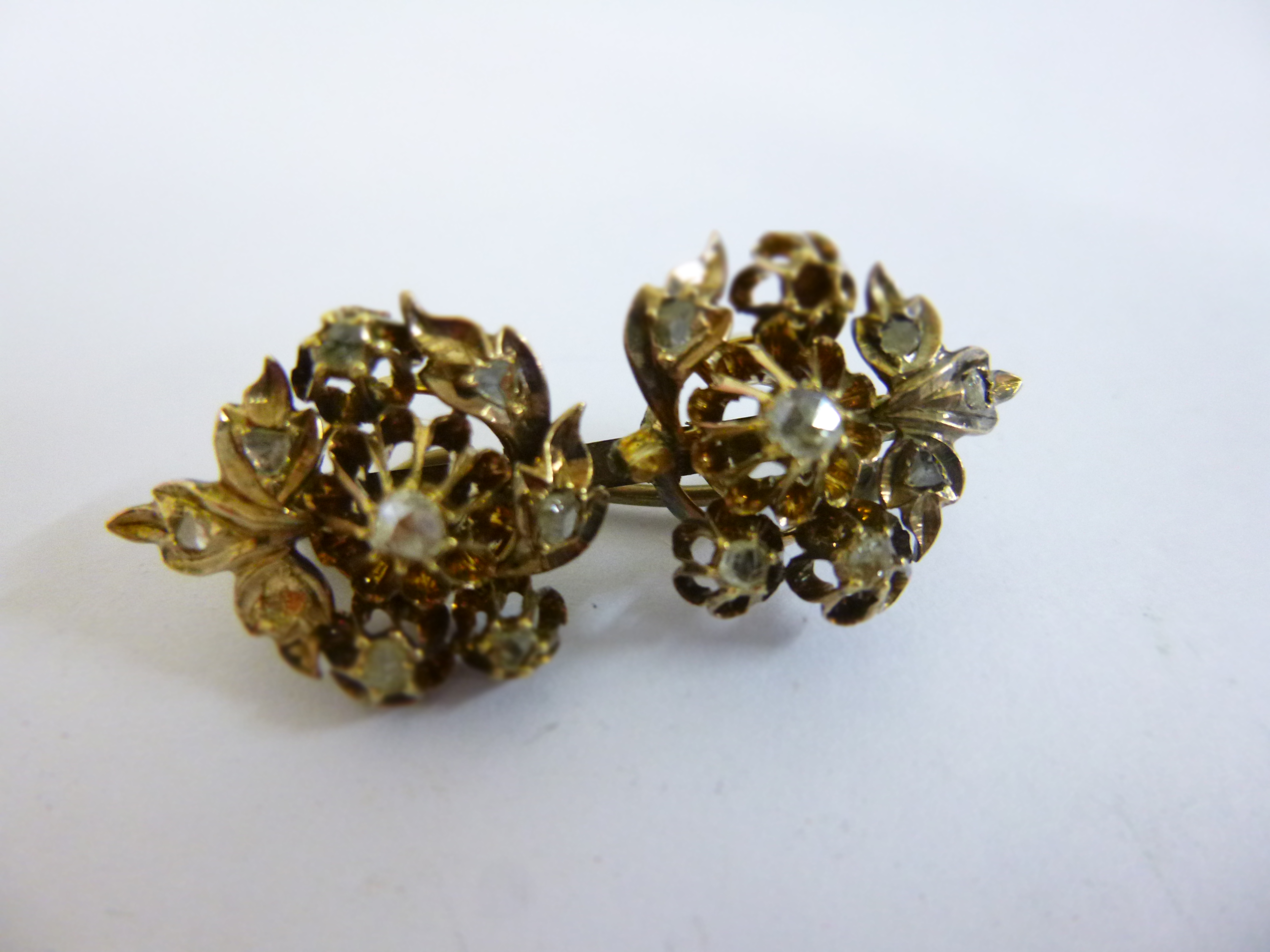 Victorian 9ct gold (tested) floral brooch inset with rose cut diamonds (two missing), 3.8cms in
