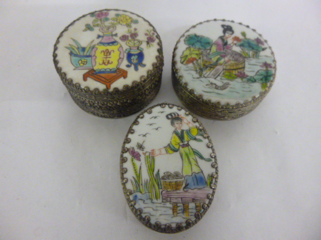 Three white metal trinket pots with famille rose decoration