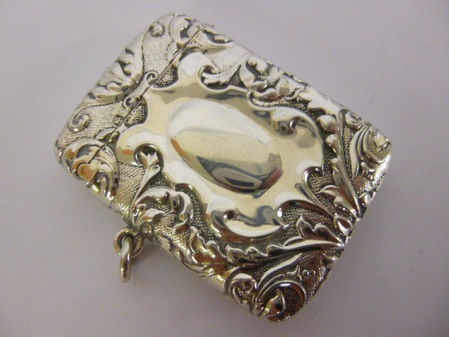 Silver vesta case with embossed foliate decoration and vacant cartouche, hallmarked Sheffield 1903