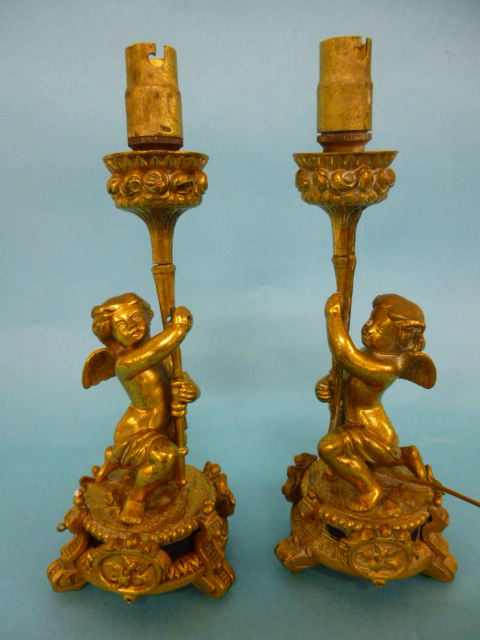 Pair of 19th Century French gilt lamp bases, each modelled as a Bacchanalian putti supporting a