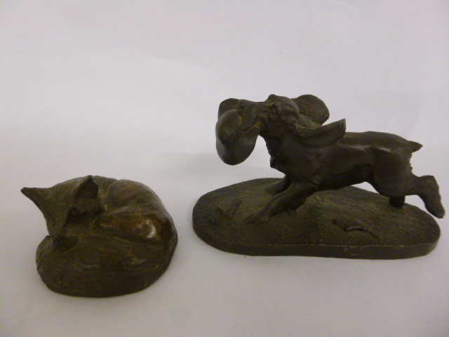 Two cold cast bronze sculptures of a running spaniel and a sleeping fox