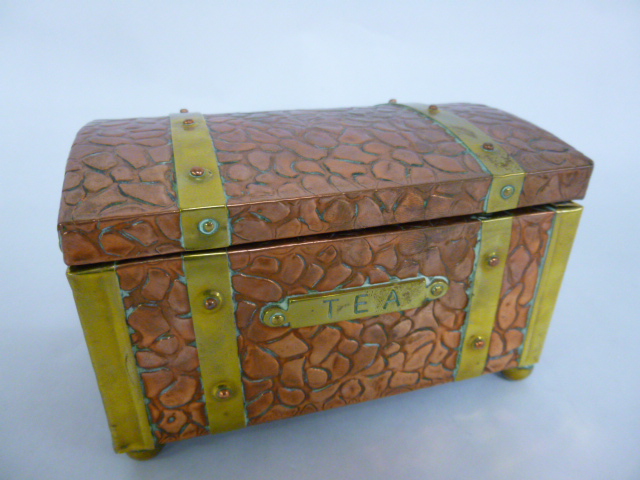 Arts & Crafts style copper and brass banded domed tea caddy on four brass ball feet, 15.5x9.5x10cms