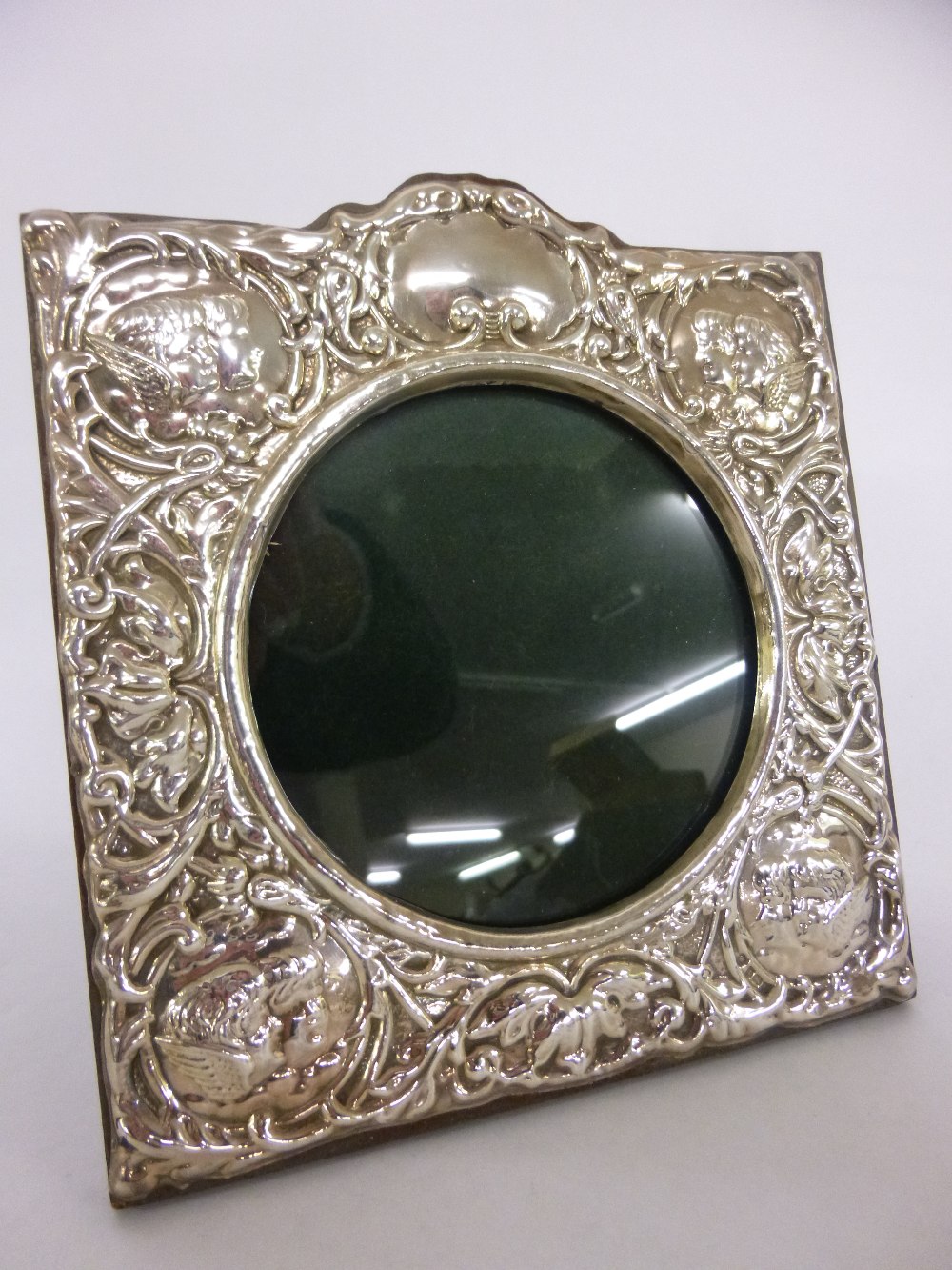 Silver photograph frame with embossed cherub decoration, hallmarked Birmingham 1995, 5.5x6"