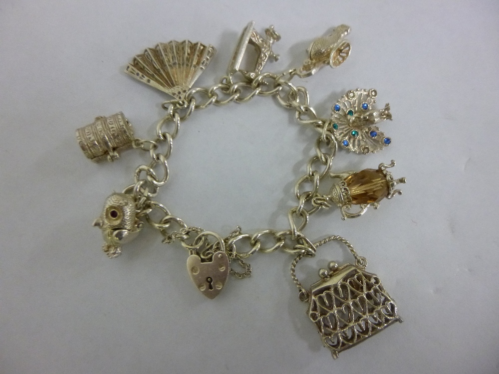 Silver charm bracelet with 8 nice quality charms, 45g