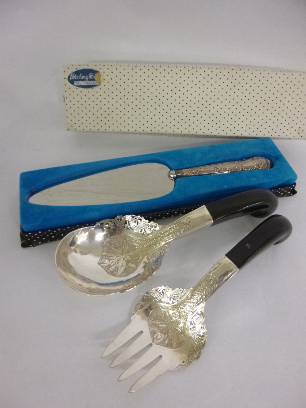 Pair of Middle Eastern white metal salad servers together with a hallmarked silver handled cake