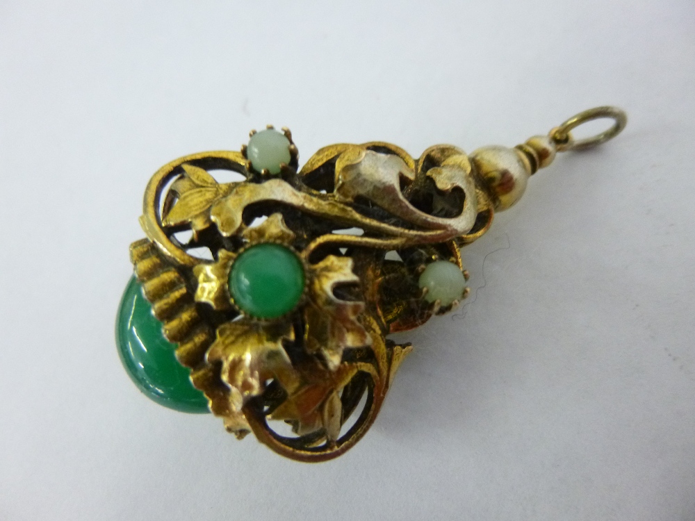 Decorative yellow metal fob pendant with trailing leaves and flowers inset with Jade