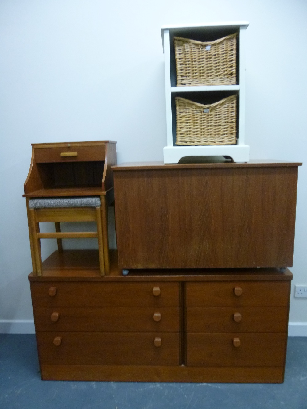 'Stag' chest of drawers, a storage chest, telephone table and a cream cupboard with baskets