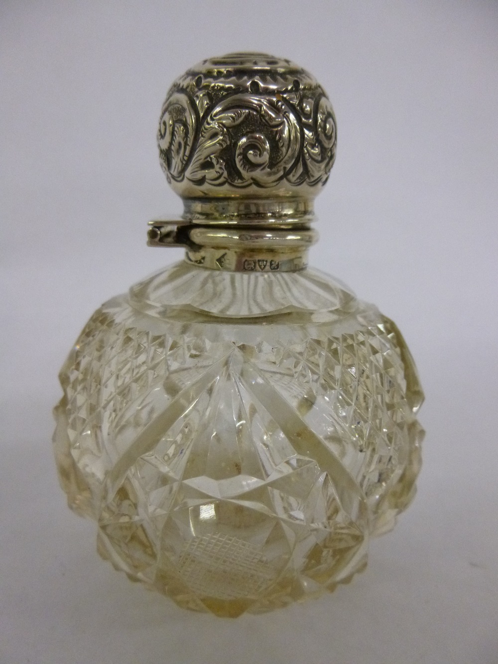 Silver topped cut glass scent bottle with inner glass stopper, hallmarked Chester 1908, 11.5cms in