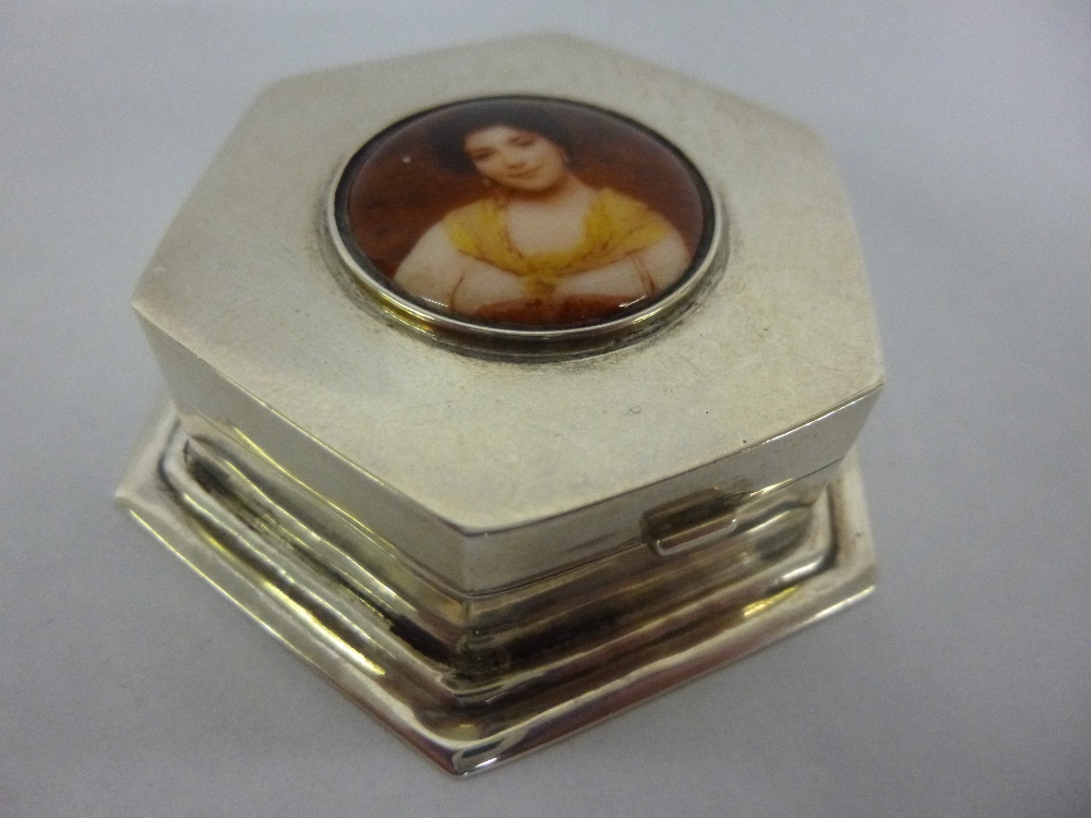 Silver hexagonal trinket box with enamel lozenge of a lady atop, base measures 6cms, 51.2g