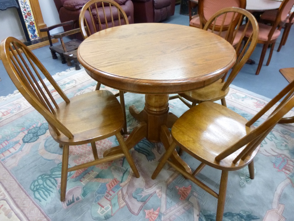 Circular teak table & four stick back chairs, 36" diameter